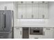 Butler's pantry showcasing sleek cabinetry, quartz countertops, and stainless steel appliances at 4139 Rockingham Dr, Raleigh, NC 27609