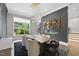Elegant dining room with modern lighting, fireplace, and sleek decor at 4139 Rockingham Dr, Raleigh, NC 27609