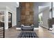 Elegant foyer featuring a designer accent wall and light hardwood floors at 4139 Rockingham Dr, Raleigh, NC 27609