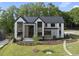 Stunning modern home with manicured lawn, walkway, and lush landscaping at 4139 Rockingham Dr, Raleigh, NC 27609