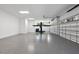 Spacious garage with epoxy floor, car lift, and abundant lighting providing functionality and sleek design at 4139 Rockingham Dr, Raleigh, NC 27609
