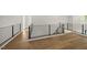 Hallway with modern black metal railings and beautiful wood flooring at 4139 Rockingham Dr, Raleigh, NC 27609