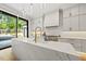 Gourmet kitchen with island, quartz countertops, stainless steel appliances, and view to the backyard at 4139 Rockingham Dr, Raleigh, NC 27609