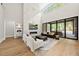 Bright living room with marble fireplace, modern furnishings, and sliding glass doors to blend indoor and outdoor living at 4139 Rockingham Dr, Raleigh, NC 27609
