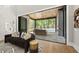 Modern living room extends to a covered outdoor space with pool views, creating seamless indoor-outdoor living at 4139 Rockingham Dr, Raleigh, NC 27609