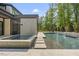 Stunning backyard pool area with an in-ground spa, lush landscaping and stepping stone walkway at 4139 Rockingham Dr, Raleigh, NC 27609