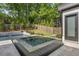 Inviting pool area with a tiled hot tub and privacy fence at 4139 Rockingham Dr, Raleigh, NC 27609