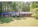 Charming brick home with well-maintained lawn and shade trees, as seen from an aerial perspective at 449 Hill Rd, Franklinton, NC 27525