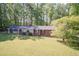 Wide aerial view of a beautiful home with mature trees and sprawling front yard, in a wooded setting at 449 Hill Rd, Franklinton, NC 27525