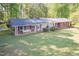 Aerial view of a brick home with a big yard and mature trees, showcasing the property's landscaping at 449 Hill Rd, Franklinton, NC 27525