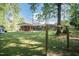Expansive backyard view showcasing the home, a sturdy swing set, and lots of green space at 449 Hill Rd, Franklinton, NC 27525