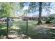 Backyard featuring a swingset, with a quaint building and traditional home in the background under mature trees at 449 Hill Rd, Franklinton, NC 27525
