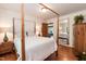 Bedroom featuring a four poster bed with hardwood floors, and an antique mirror at 449 Hill Rd, Franklinton, NC 27525