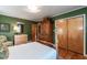 Bedroom with a four poster bed, wooden armoire, and green walls at 449 Hill Rd, Franklinton, NC 27525