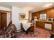 Eat-in kitchen and dining room with oak cabinets and decorative rug at 449 Hill Rd, Franklinton, NC 27525