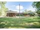 Charming brick home on a lush green lawn with a convenient carport and inviting back deck at 449 Hill Rd, Franklinton, NC 27525