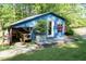 Charming blue building featuring a covered area, adjacent to an outdoor patio with lovely garden decor at 449 Hill Rd, Franklinton, NC 27525