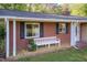 Charming brick home with black shutters, a cozy front porch, and curb appeal at 449 Hill Rd, Franklinton, NC 27525