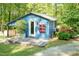 Charming blue building with a covered area featuring an outdoor patio with lovely floral decor and lush greenery at 449 Hill Rd, Franklinton, NC 27525