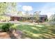 Lovely brick home boasts an inviting front yard, carport, and deck perfect for outdoor enjoyment at 449 Hill Rd, Franklinton, NC 27525