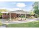 Brick home features a spacious carport and a welcoming deck overlooking the expansive yard at 449 Hill Rd, Franklinton, NC 27525