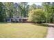 Spacious single-story brick home with a sprawling lawn, mature trees, and inviting curb appeal at 449 Hill Rd, Franklinton, NC 27525