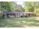 Charming brick home with a well-manicured lawn and a cozy bench near the front entrance at 449 Hill Rd, Franklinton, NC 27525