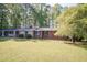 Inviting front exterior with a lush lawn and mature trees providing privacy and shade around the home at 449 Hill Rd, Franklinton, NC 27525