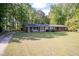 Well-maintained brick home with lush front lawn and mature trees offering shade and privacy at 449 Hill Rd, Franklinton, NC 27525