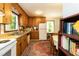 This kitchen features wooden cabinets, a white refrigerator, and plenty of natural light at 449 Hill Rd, Franklinton, NC 27525