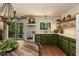 Bright kitchen showcases green cabinets, open shelving, and backyard access, blending style and function at 449 Hill Rd, Franklinton, NC 27525