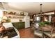 Traditional kitchen with custom green cabinetry, open shelving, and a dining area with an oversized chandelier at 449 Hill Rd, Franklinton, NC 27525