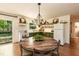 Well-lit kitchen with green cabinets, a large table, and backyard views, creating a welcoming space at 449 Hill Rd, Franklinton, NC 27525