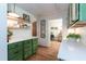 Traditional kitchen with custom green cabinetry, open shelving, and light countertops and views to the living area at 449 Hill Rd, Franklinton, NC 27525