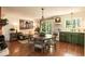 Charming kitchen with green cabinets, wood floors, and a dining area, perfect for Gathering meals at 449 Hill Rd, Franklinton, NC 27525