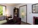 Cozy living room with a window, bookshelf, and front door access at 449 Hill Rd, Franklinton, NC 27525