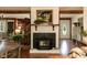 Cozy living room featuring a brick fireplace with a wooden mantel and beams at 449 Hill Rd, Franklinton, NC 27525