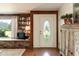 Living room featuring built-in bookshelves, a window seat, and a decorative front door enhancing the home's character at 449 Hill Rd, Franklinton, NC 27525