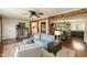 Inviting living room with exposed wood beams, hardwood floors, and views into the open kitchen and dining areas at 449 Hill Rd, Franklinton, NC 27525