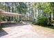 Property features a long driveway, carport, additional blue shed, and expansive lawn area at 449 Hill Rd, Franklinton, NC 27525