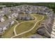 An aerial view of a planned community shows many homes and walking paths surrounding a large green space at 450 Shale Creek Dr, Durham, NC 27703