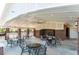 Outdoor seating area at the amenity center, featuring tables, chairs, fireplace, and ceiling fan at 450 Shale Creek Dr, Durham, NC 27703