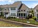 View of a home's backyard with a screened in porch, fence, and landscaping on a sunny day at 450 Shale Creek Dr, Durham, NC 27703