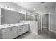 Well-lit bathroom with double sink vanity, framed mirror, and glass-enclosed shower at 450 Shale Creek Dr, Durham, NC 27703