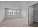 Bright, carpeted bedroom features three windows offering natural light and a closet at 450 Shale Creek Dr, Durham, NC 27703