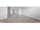 Neutral carpeted bedroom showcasing white trim, baseboards, and two white doors at 450 Shale Creek Dr, Durham, NC 27703