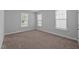 Bright, neutral bedroom with carpeted floor and multiple windows allowing for natural light at 450 Shale Creek Dr, Durham, NC 27703