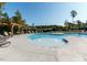 Community pool with comfortable lounge chairs, pergola, and a lush green tree line at 450 Shale Creek Dr, Durham, NC 27703