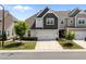 Well-maintained townhouse with attached garage, manicured lawn, and mature landscaping at 450 Shale Creek Dr, Durham, NC 27703