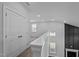 Upstairs hallway with white walls, carpet floor, and a view of downstairs windows at 450 Shale Creek Dr, Durham, NC 27703